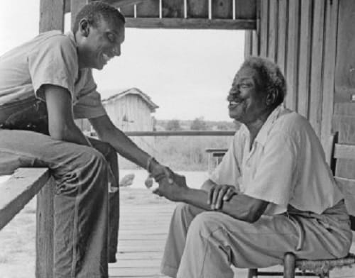 Stokely Carmichael talking with a local person about the Lowndes County Freedom Organization (LCFO) in 1966.