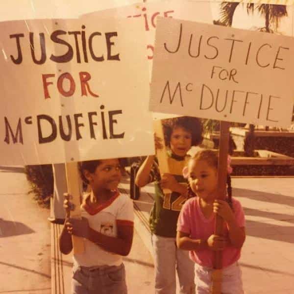 Young kids holding up protest signs at the first demonstration calling for justice for Arthur McDuffie.