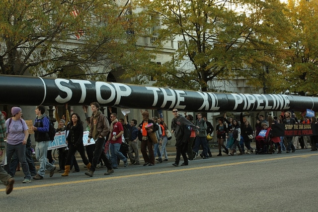 Protesters with pipeline replica. Source: Texas Standard