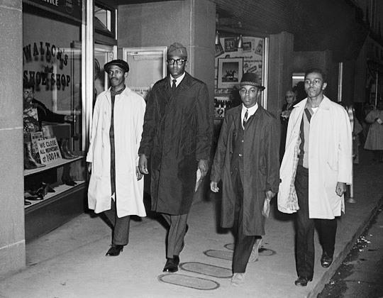 Feb. 1, 1960, Greensboro, NC: The participants after leaving the Woolworth's by a side exit. The four are (L-R): Richmond, McCain, Blair, and McNeil. (No photographers were allowed into Woolworth's during this first protest.) Image: © Corbis.