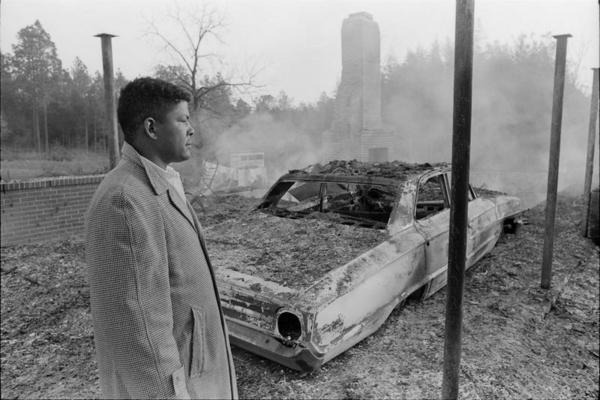 Jan. 10, 1966: Voting Rights Activist Vernon Dahmer is Murdered (This Day in History) -- Harold Dahmer looks over the smoking ruins of his family's home and car | Zinn Education Project: Teaching People's History