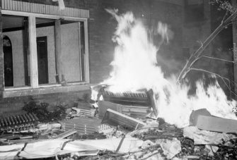 Black and white photograph of a burning piano