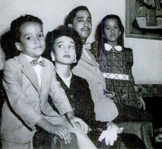 Black and white photograph of a family with two adult parents and two children.