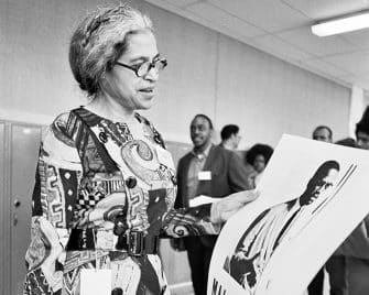 Rosa Parks at the National Black Political Convention in Gary, Indiana, March 1972, looking at a poster of Malcolm X.