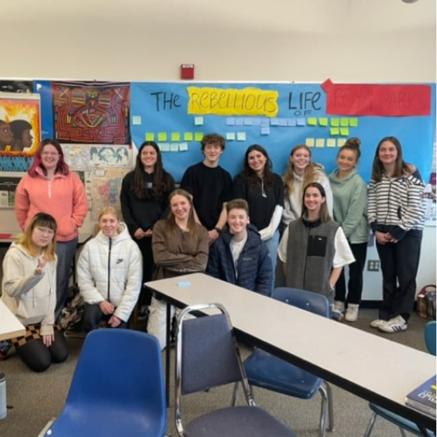 classroom students standing in front of their completed Rosa Parks lesson assignment.