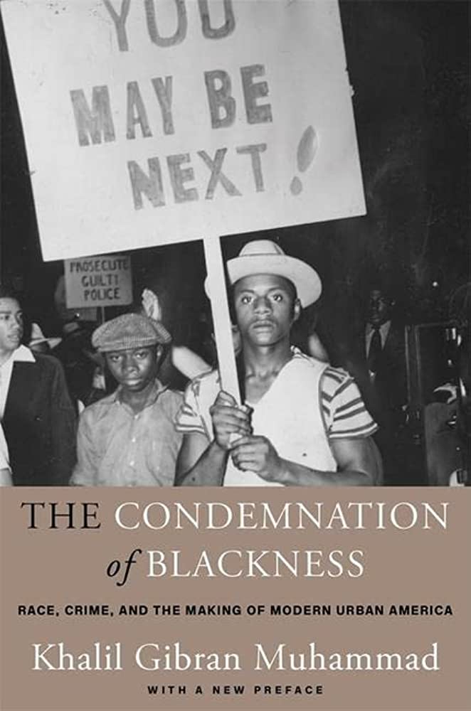 book cover showing young Black man holding a protest sign.