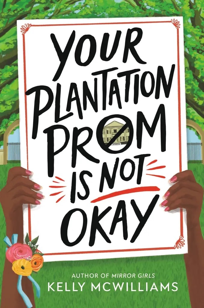 hands holding up a sign reading "Your Plantation Prom is Not Okay"