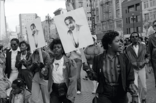 Marchers holding MLK signs during the first national Martin Luther King Jr. holiday in San Francisco, circa 1986.
