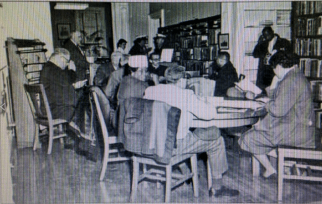 Black and white photo of people sitting at a table during the McKenney Public Library sit-in in Petersburg, Virginia.
